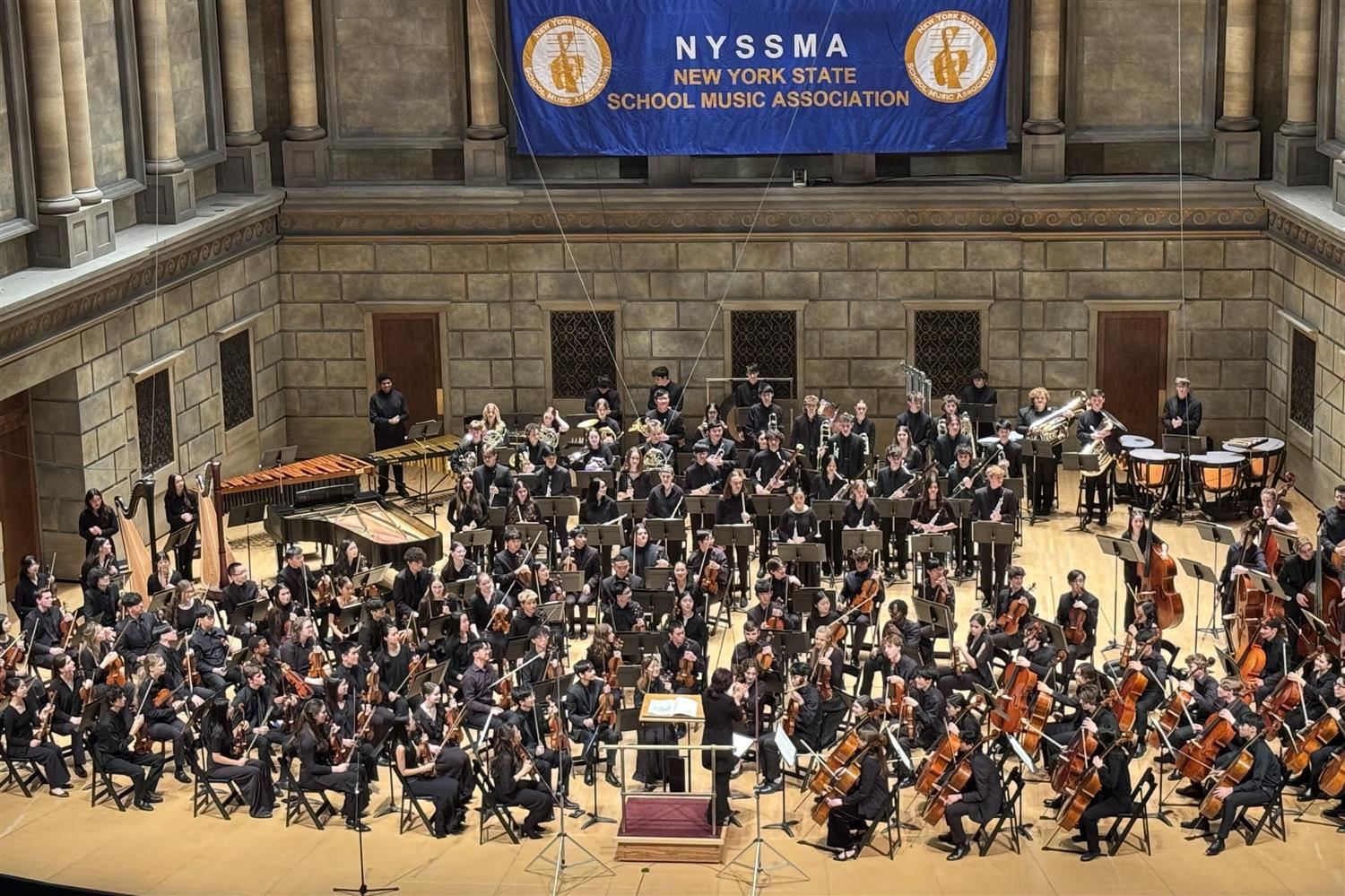 The All-State Symphony Orchestra performing at the 2024 NYSSMA Winter Conference